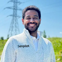 Portrait of Alex Peats-Bond outdoors in front of a transmission tower