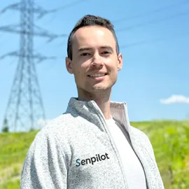 Portrait of Mike Hejmej outdoors in front of a transmission tower